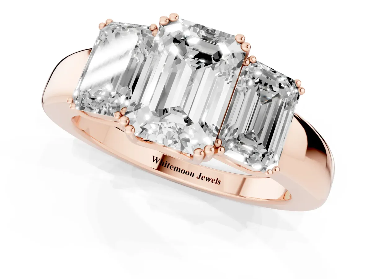 Three-Stone Emerald Cut Cut Diamond Ring with Channel Set Band and Four-Prong Setting Rose gold