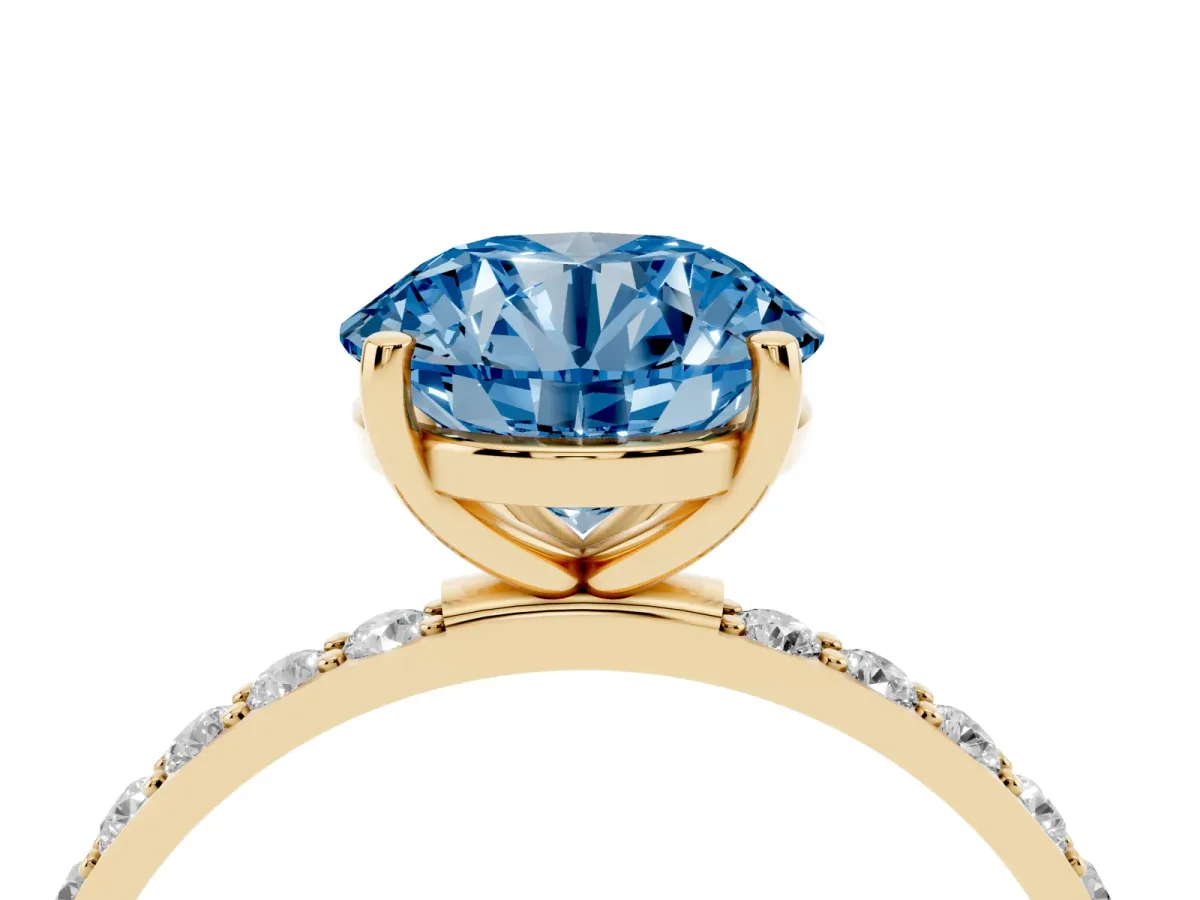 Fancy Blue Round Cut Diamond Solitaire Ring with Round Pavé Shoulders and Prong Setting Yellow gold