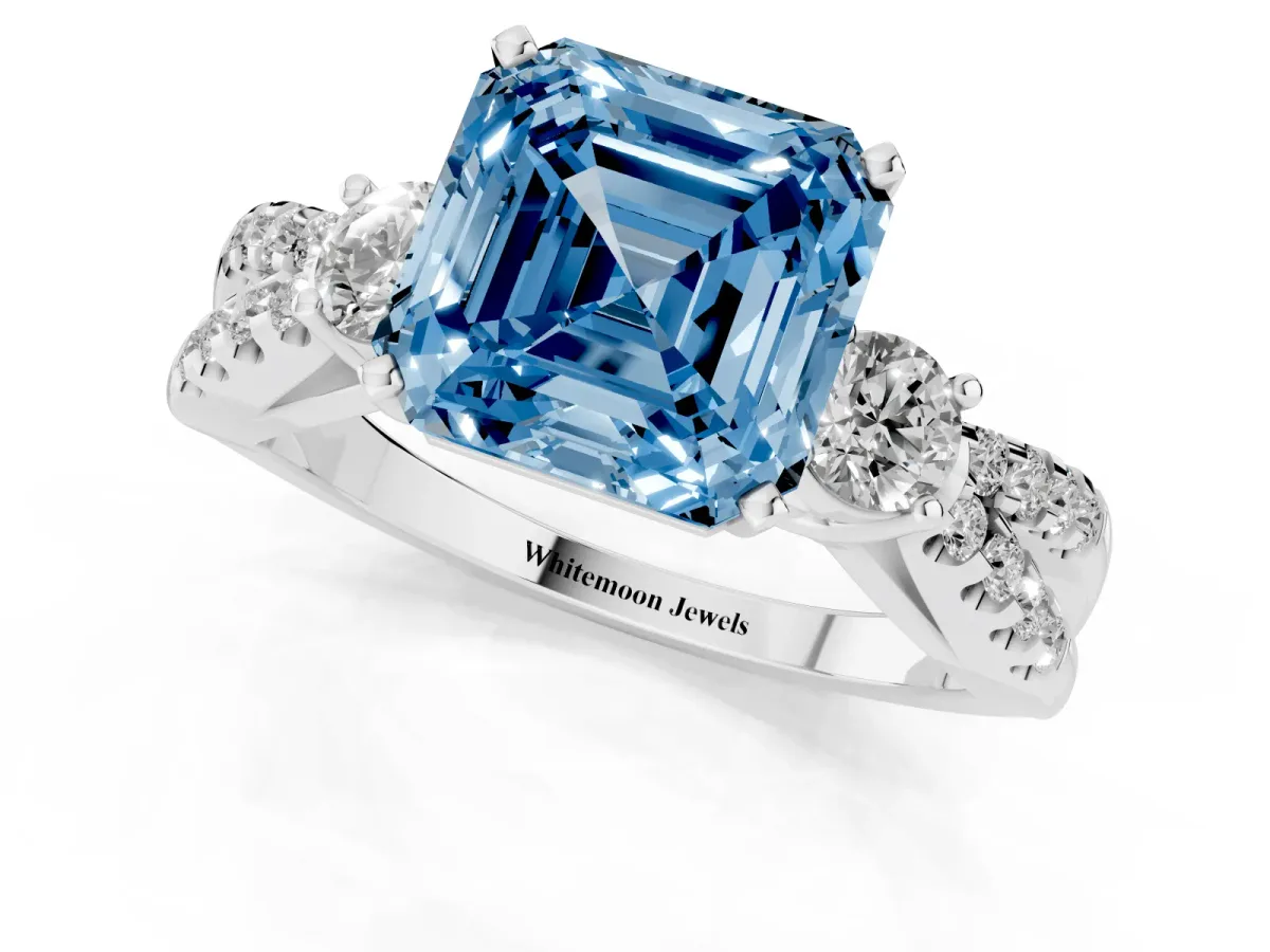 Fancy Blue Asscher Cut Diamond Three-Stone Ring with Pavé Split Shank and Four-Prong Setting Platinum