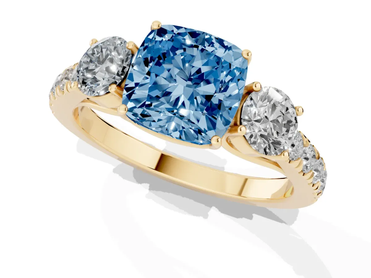 Fancy Blue Cushion Cut Cut Diamond Three-Stone Ring with Round Side Stones and Pavé Band Yellow gold