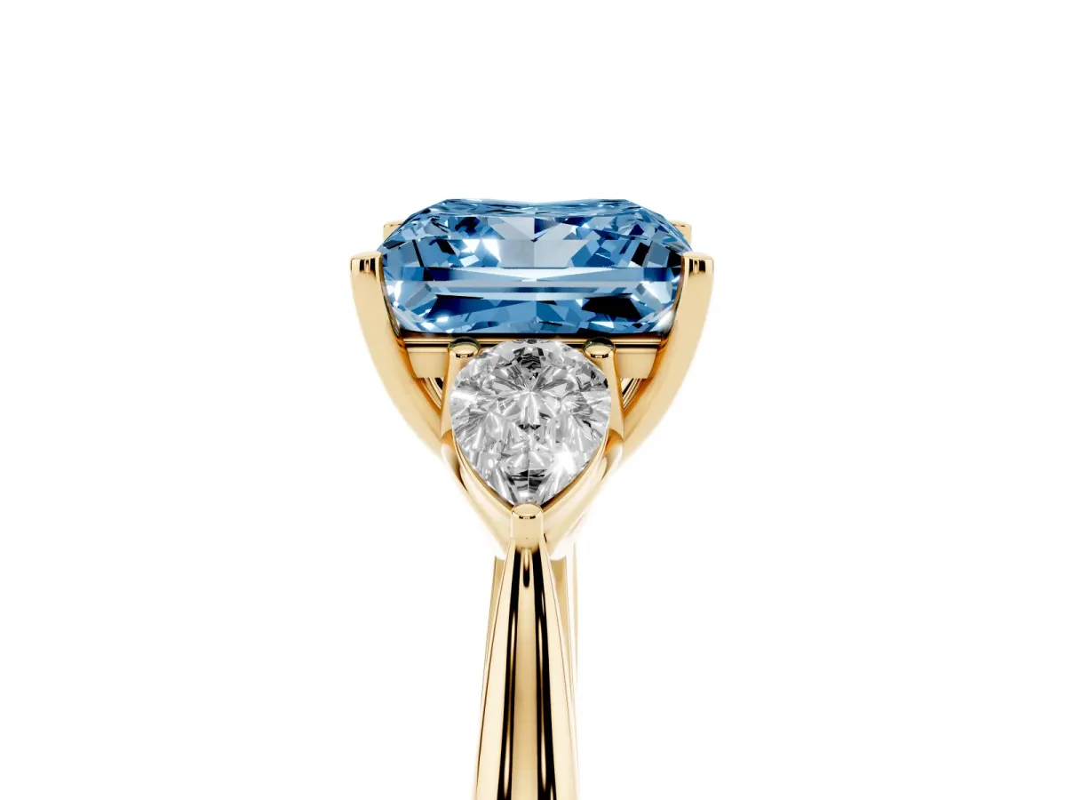 Fancy Blue Three-Stone Princess Cut Brilliant Diamond Solitaire Ring with Tapered Band and Four-Prong Setting Yellow gold