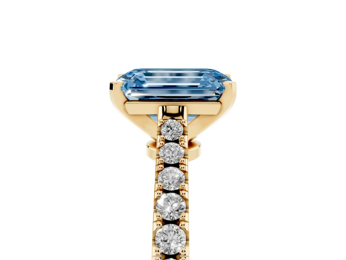 Fancy Blue Emerald Cut Cut Solitaire Diamond Engagement Ring with Pave Band and Four-Prong Setting Yellow gold