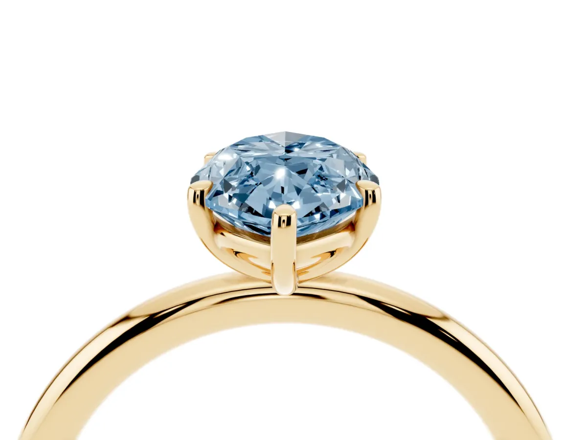Fancy Blue Oval Cut Solitaire Diamond Ring with Four-Prong Setting on a Plain Band Yellow gold