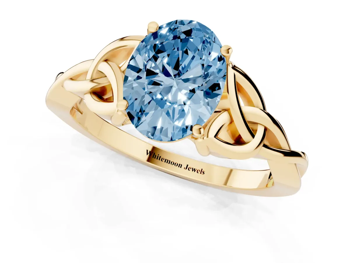 Fancy Blue Oval Cut Diamond Solitaire Engagement Ring with Celtic Knot Band and Four-Prong Setting Yellow gold