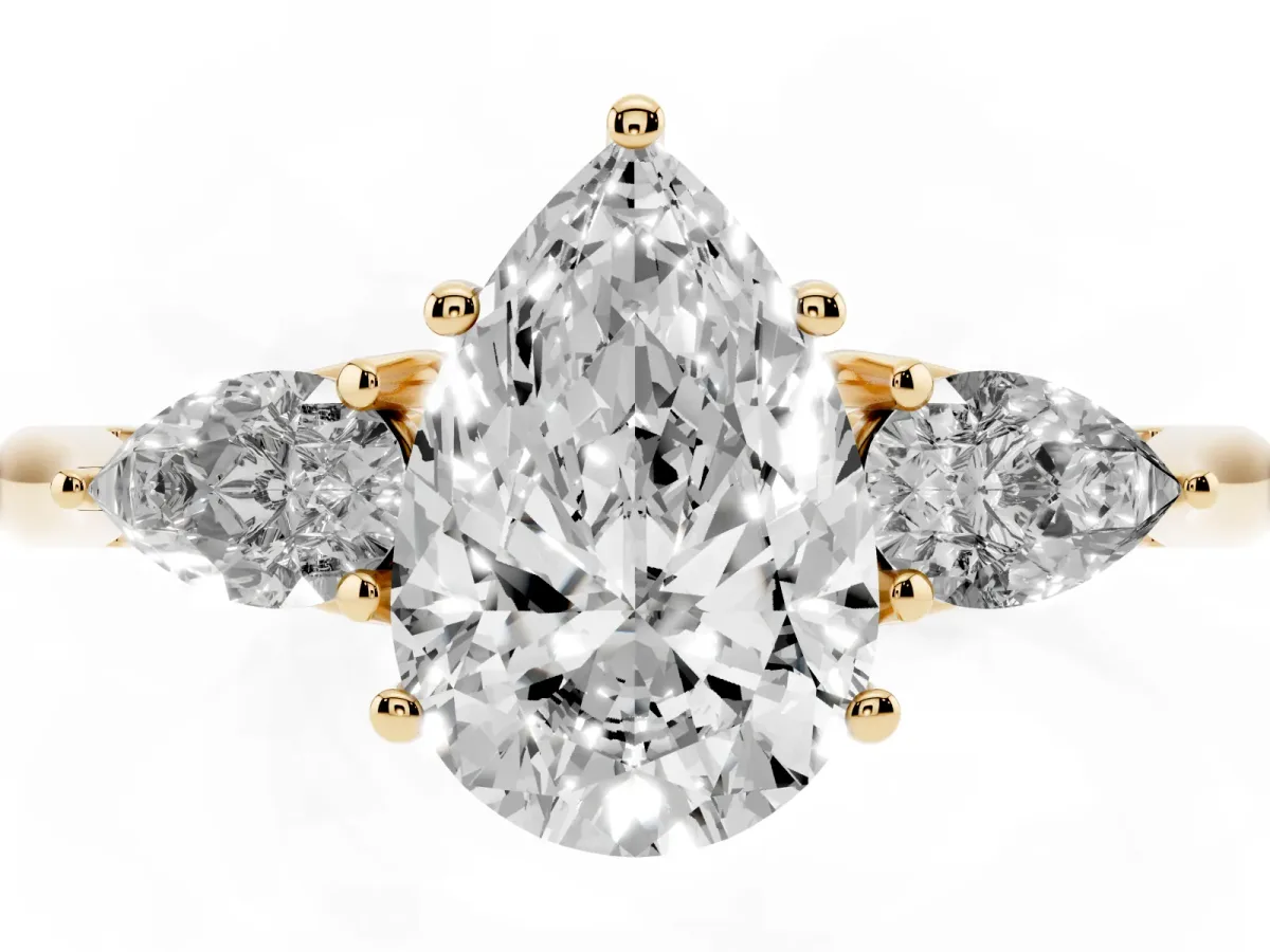 Three-Stone Pear Cut Brilliant Diamond Solitaire Ring with Tapered Band and Four-Prong Setting Yellow gold