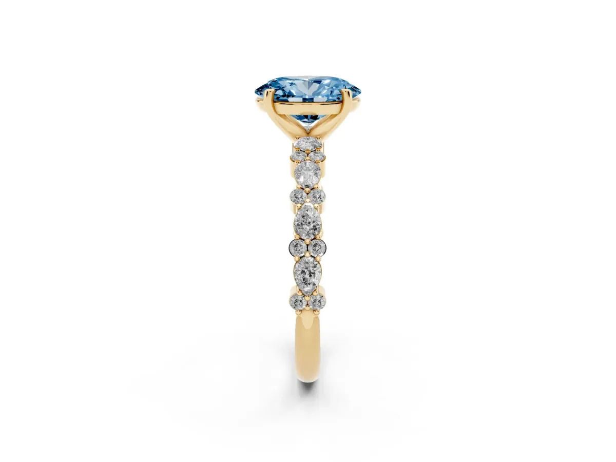 Fancy Blue Oval Cut Diamond Side Stone Solitaire Ring with Round and Four-Prong Setting Yellow gold
