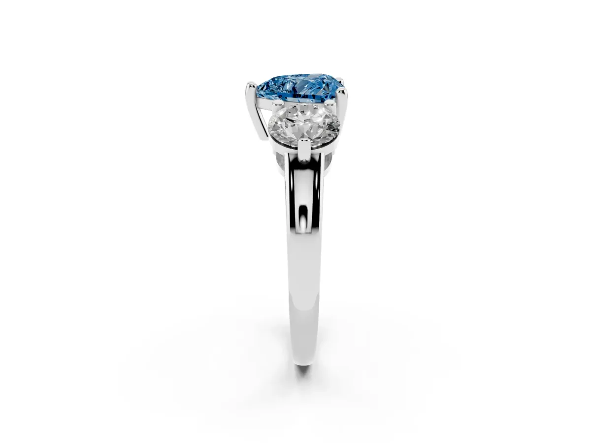 Fancy Blue Three-Stone Heart Cut Brilliant Cut Solitaire Ring with Prong Setting on a Classic Band Silver