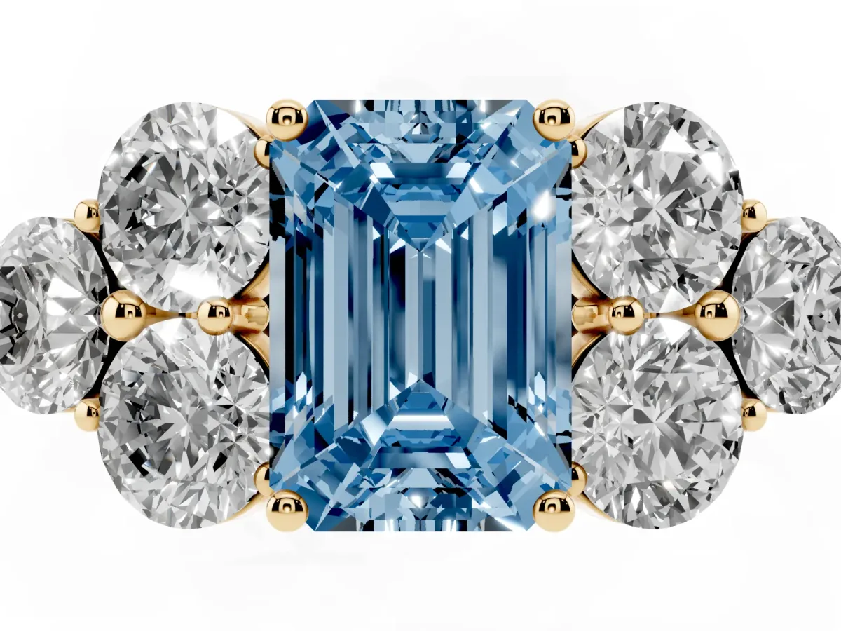 Fancy Blue Emerald Cut Cut Diamond Cluster Ring with Round Accent Stones and Prong Setting on a Classic Band Yellow gold