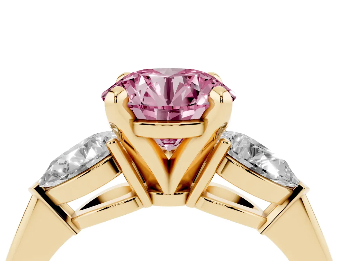Fancy Pink Three-Stone Round Cut Diamond Ring with Pear Side Stones and Four-Prong Setting Yellow gold