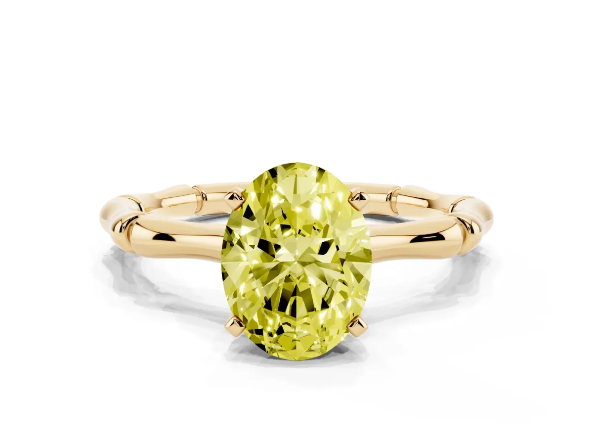 Fancy Yellow Oval Cut Solitaire Diamond Ring with Bamboo Band and Four-Prong Setting Yellow gold