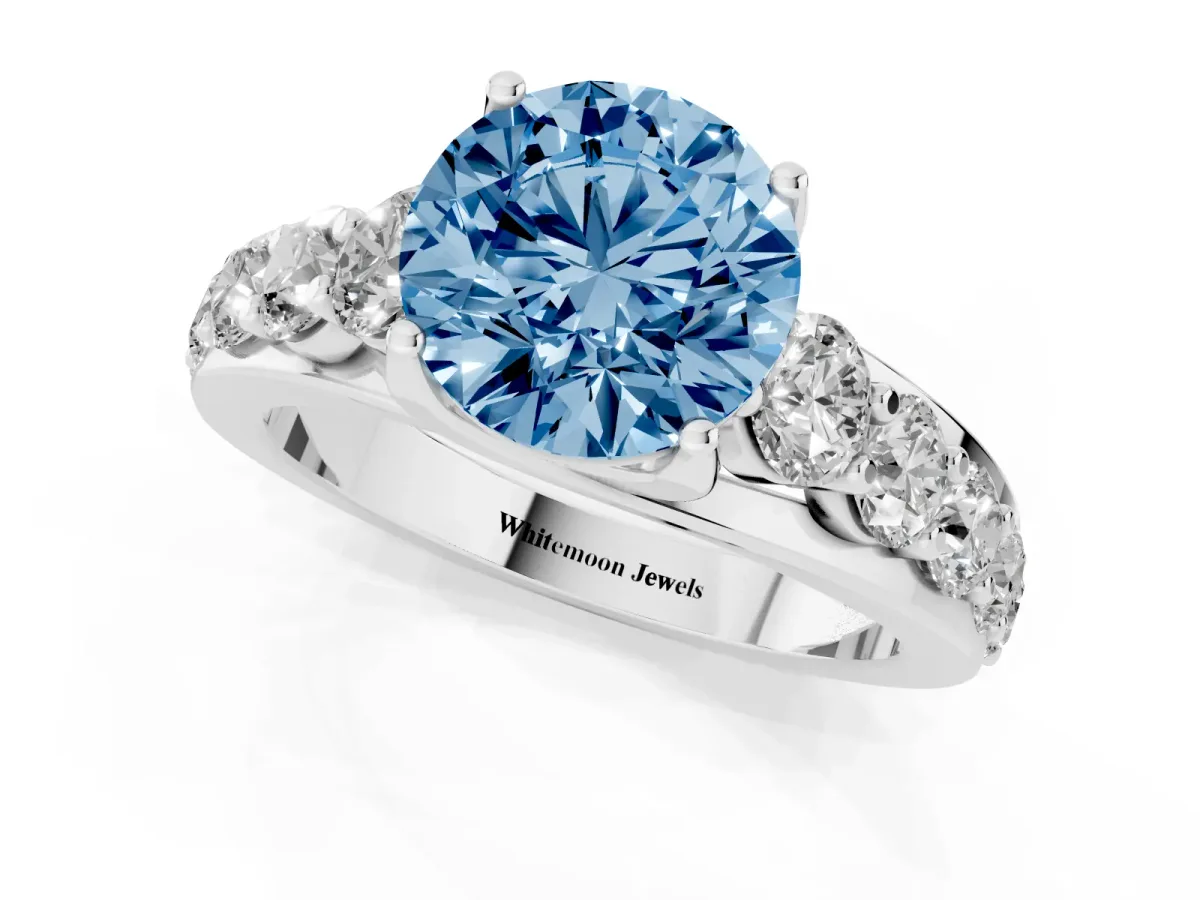 Fancy Blue Round Cut Diamond Engagement Ring with Pavé Band and Four-Prong Setting Silver