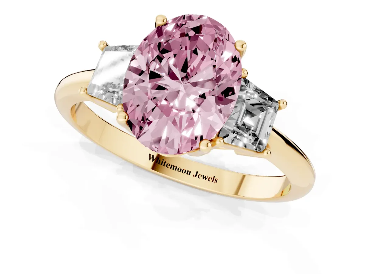 Fancy Pink Oval Cut Diamond Three-Stone Ring with Trapezoid Side Stones and Prong Setting Yellow gold