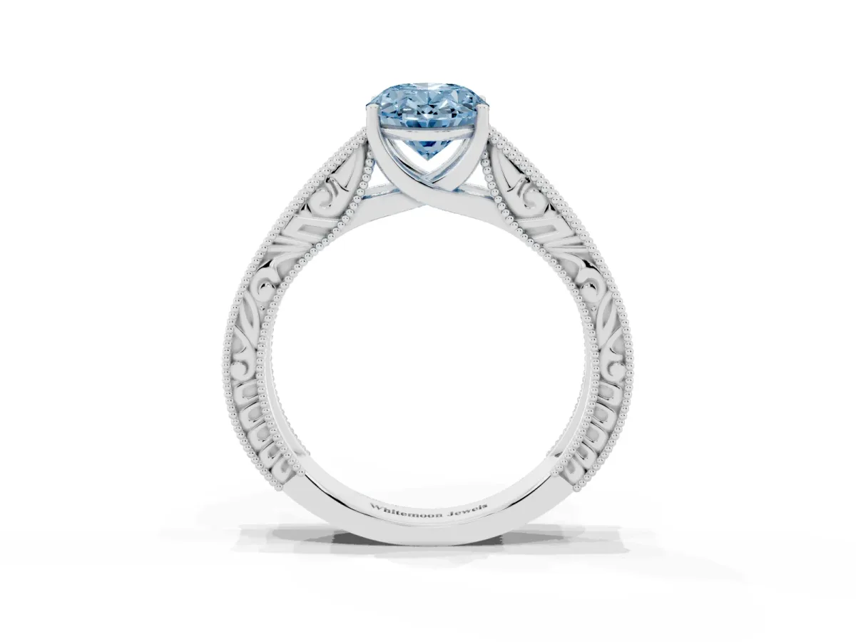 Fancy Blue Oval Cut Diamond Solitaire Ring with Engraved Band and Four-Prong Setting Silver