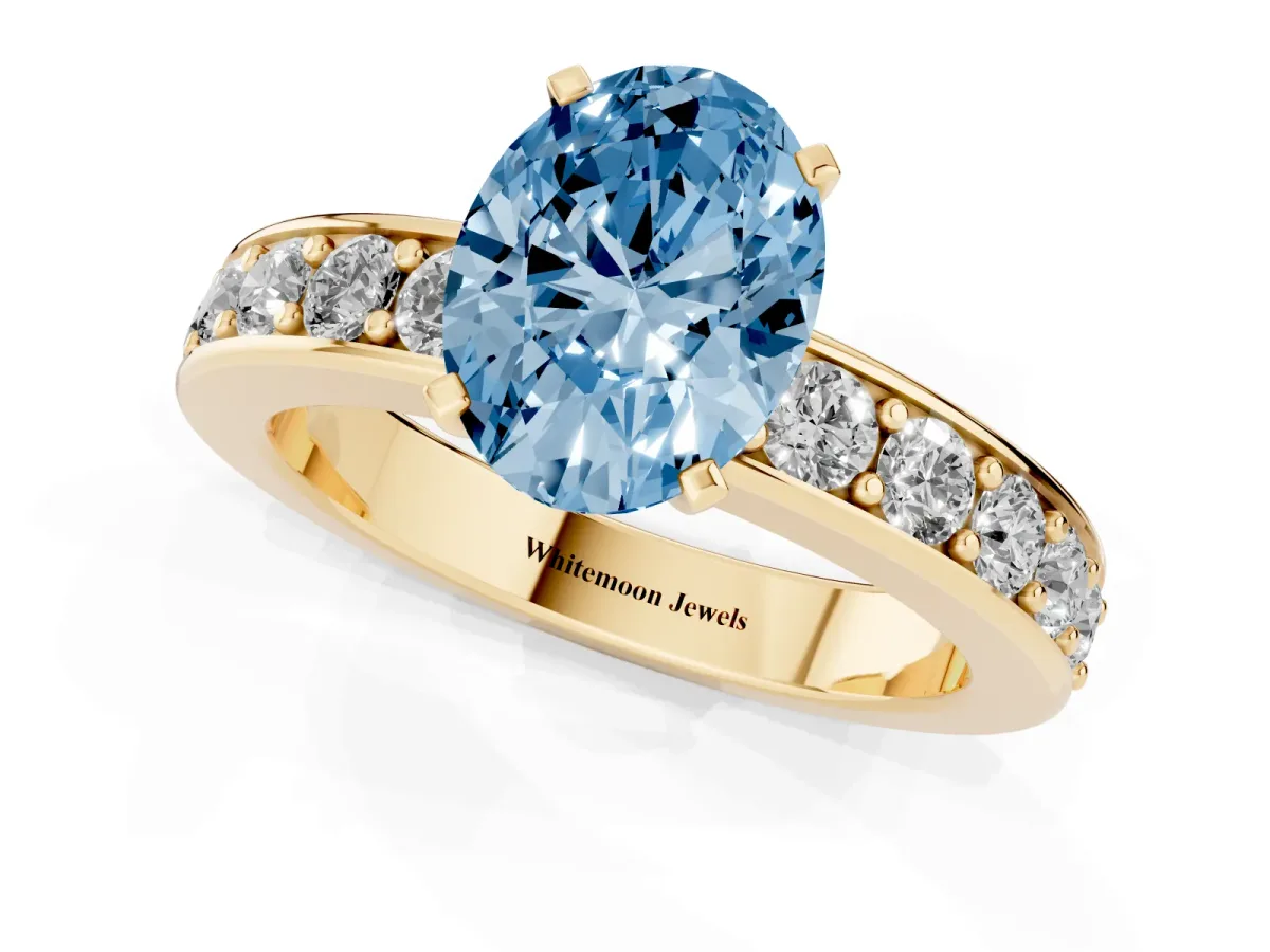 Fancy Blue Oval Cut Diamond Engagement Ring with Channel Set Round Band and Prong Setting Yellow gold