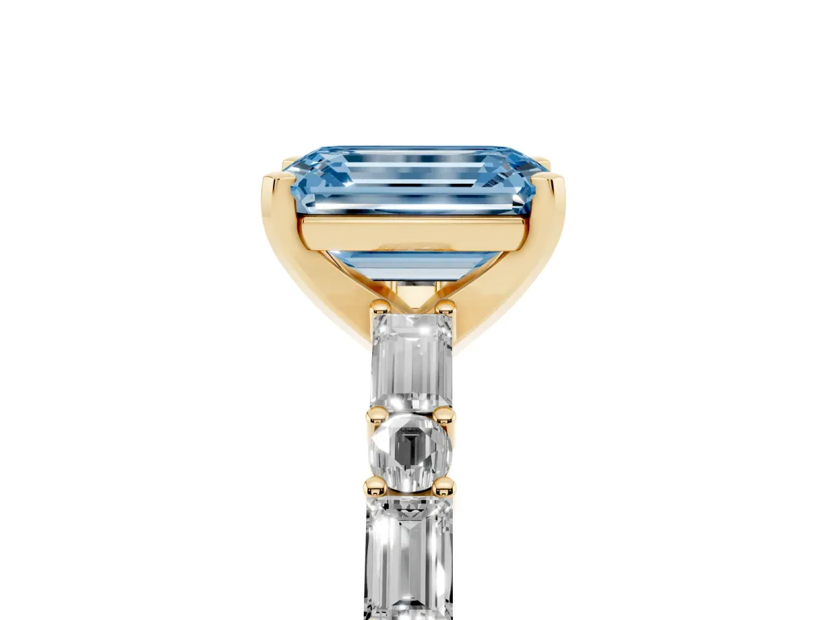Fancy Blue Emerald Cut Diamond Solitaire with Side Baguettes and Channel Set Band Yellow gold
