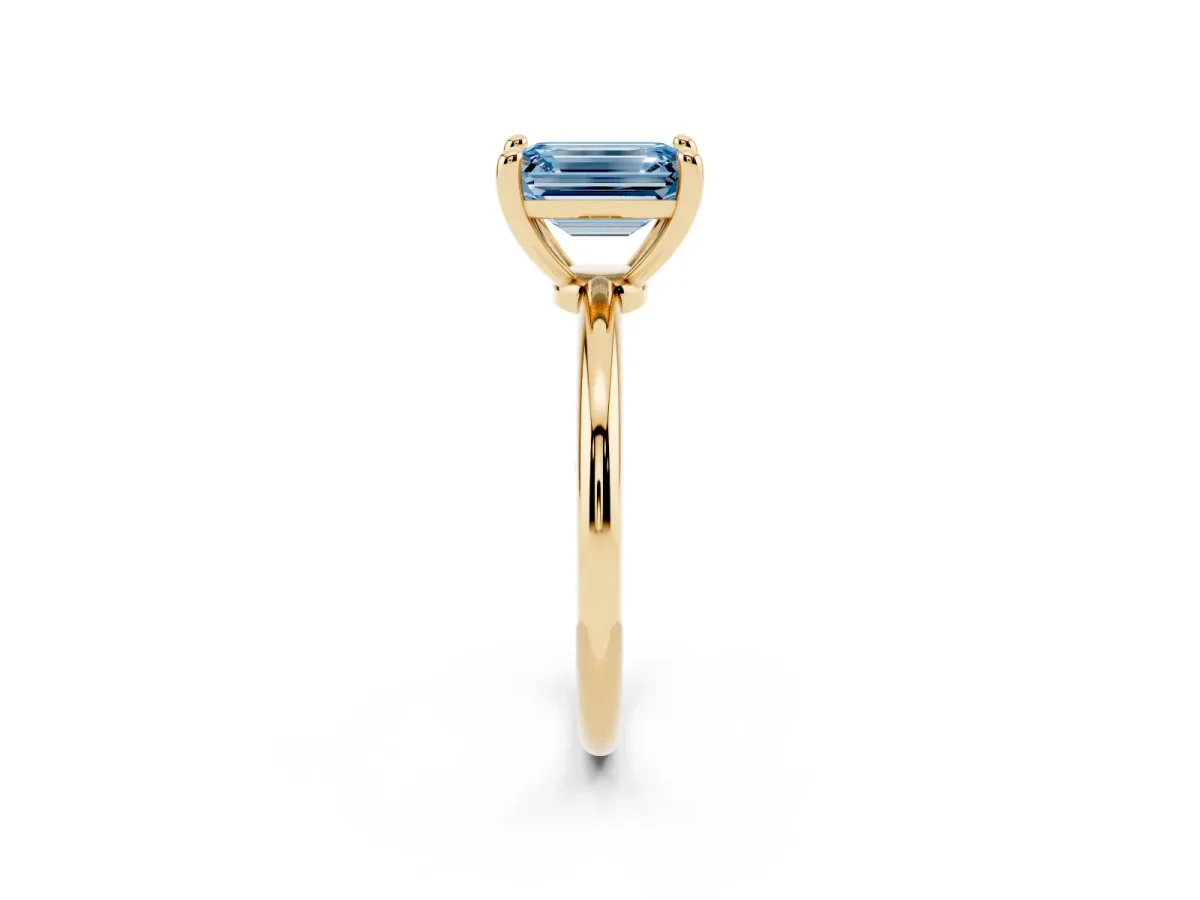 Fancy Blue Emerald Cut Solitaire Diamond Ring with 4-Prong Setting on a Classic Band Yellow gold