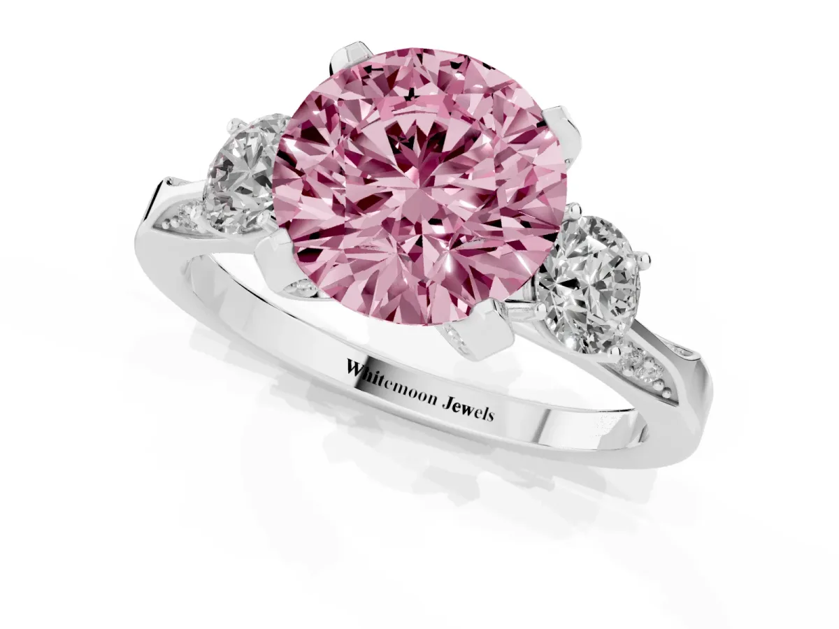 Fancy Pink Round Cut Brilliant Three-Stone Diamond Ring with Pavé Band and Four-Prong Setting White gold