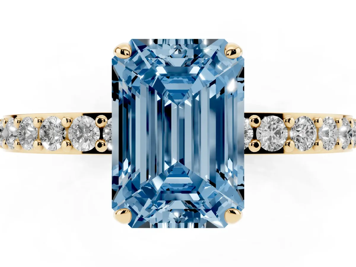 Fancy Blue Emerald Cut Diamond Solitaire Engagement Ring with Pavé Band and Four-Prong Setting Yellow gold