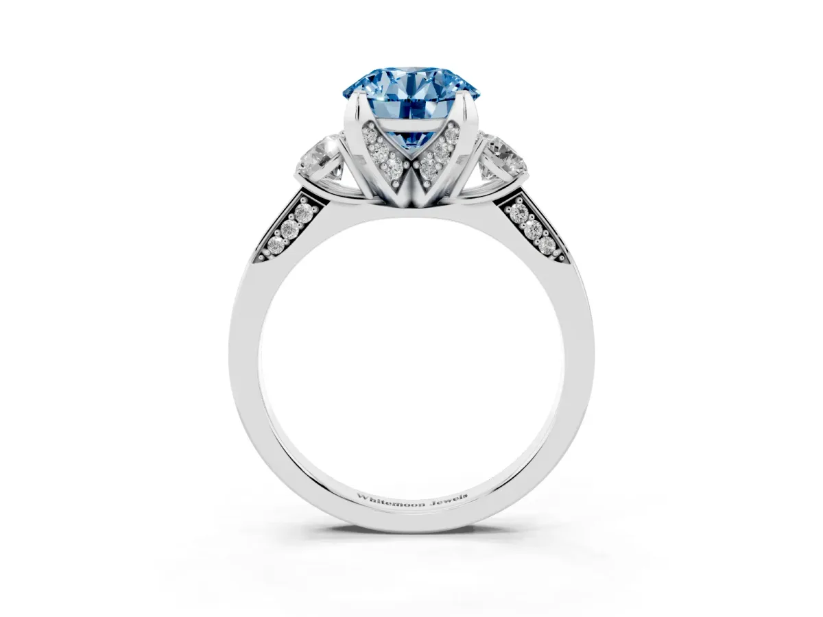 Fancy Blue Round Cut Brilliant Three-Stone Diamond Ring with Pavé Band and Four-Prong Setting Silver