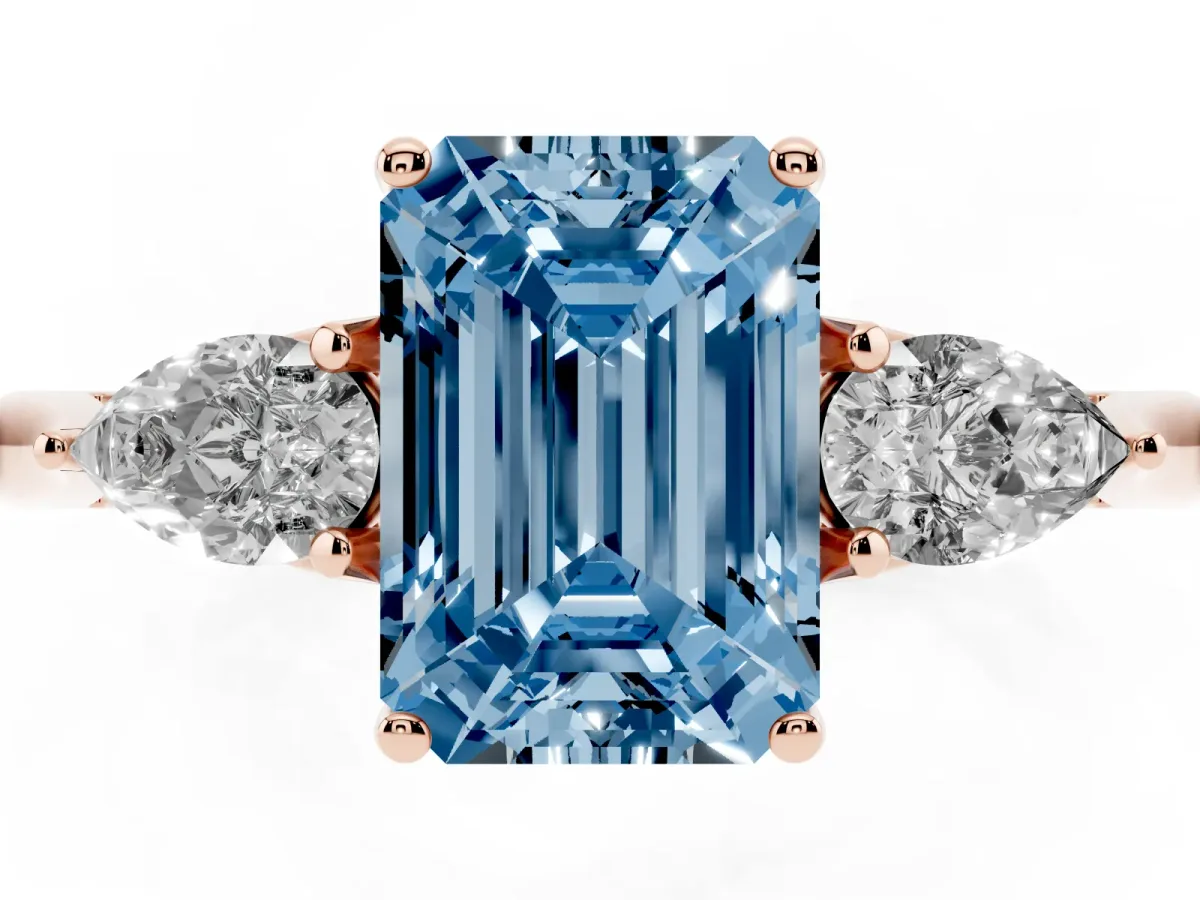 Fancy Blue Three-Stone Emerald Cut Brilliant Diamond Solitaire Ring with Tapered Band and Four-Prong Setting Rose gold