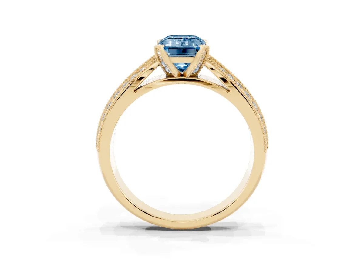 Fancy Blue Emerald Cut Diamond Solitaire Ring with Milgrain Round Pavé Band and Prong Setting Yellow gold
