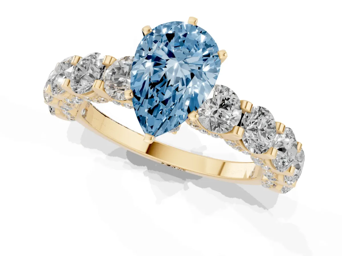 Fancy Blue Pear Cut Diamond Side Stone Engagement Ring with Four-Prong Setting Yellow gold