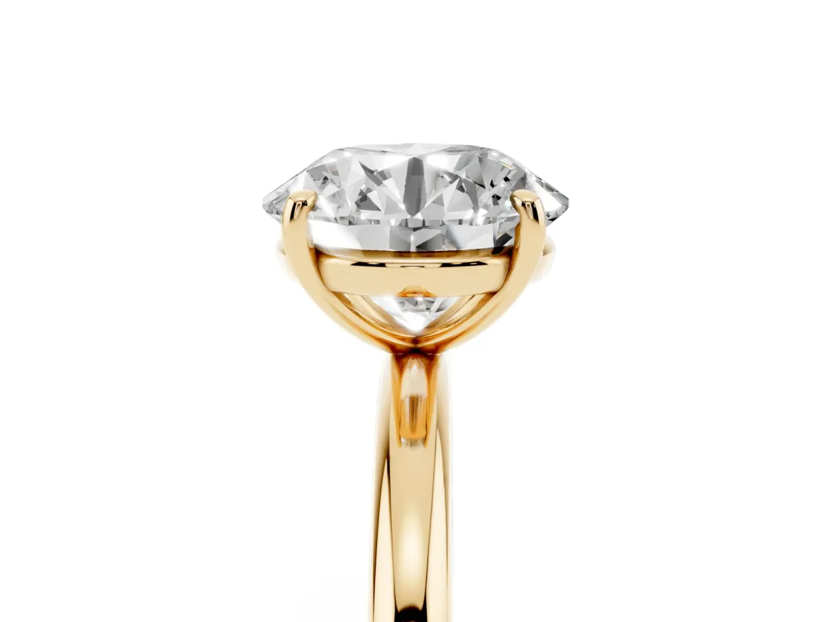 Round Cut Solitaire Diamond Ring with Four-Prong Setting on a Plain Band Yellow gold