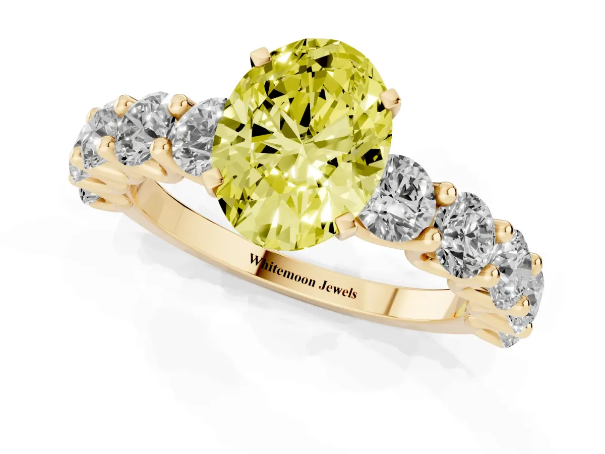 Fancy Yellow Oval Cut Diamond Prong Setting with Side Stones on a Pave Band Yellow gold
