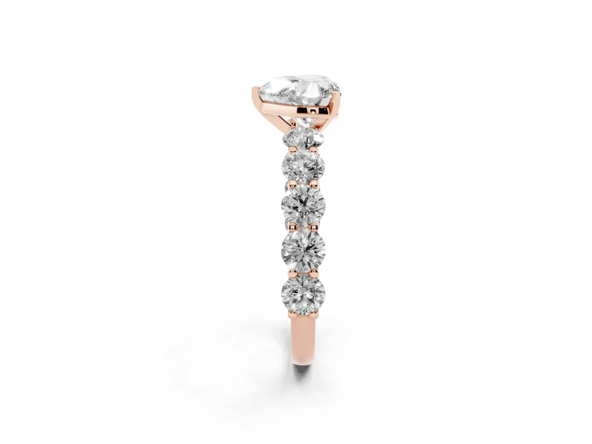 Heart Cut Diamond Prong Setting with Side Stones on a Pave Band Rose gold