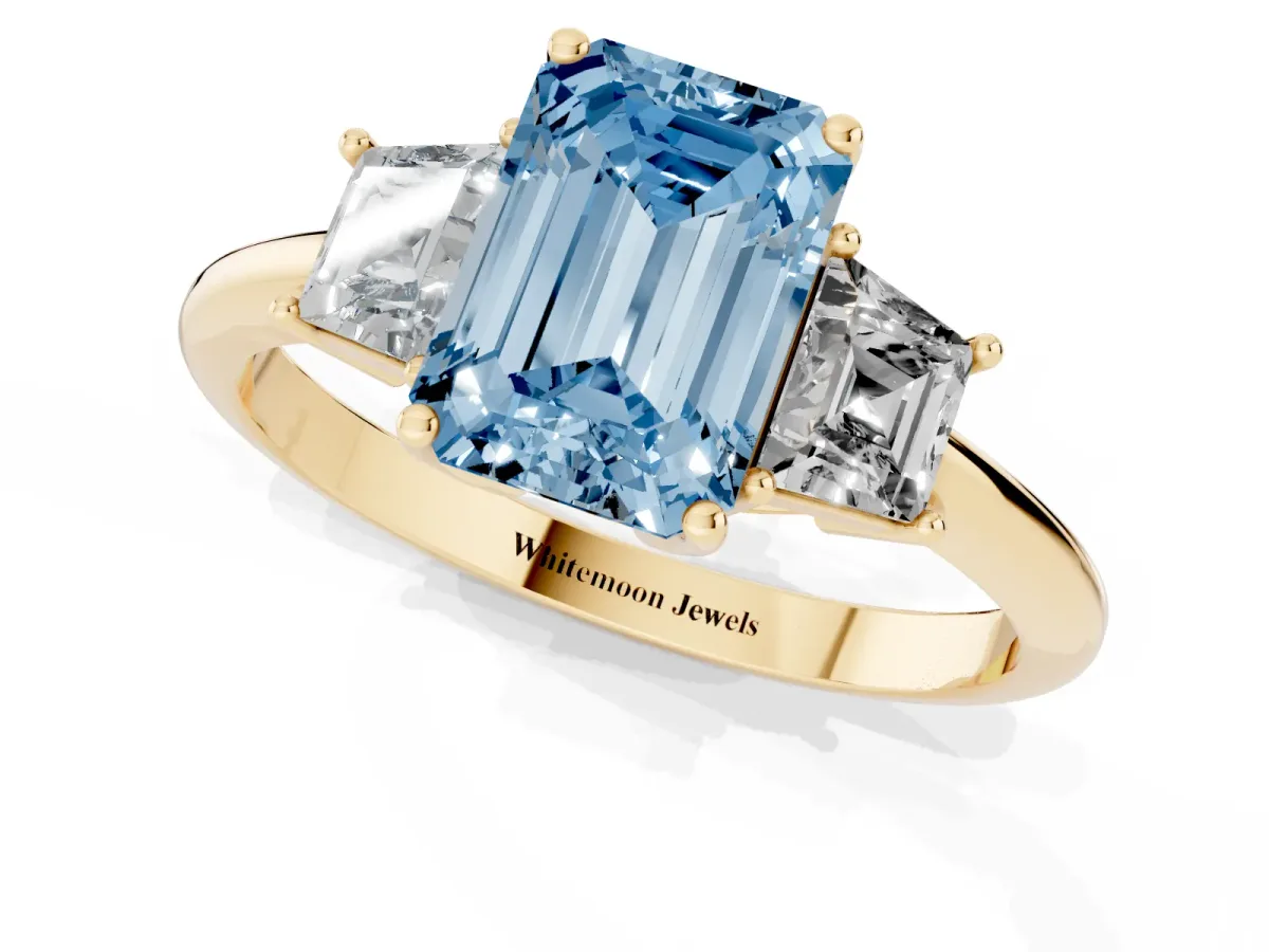 Fancy Blue Emerald Cut Diamond Three-Stone Ring with Trapezoid Side Stones and Prong Setting Yellow gold
