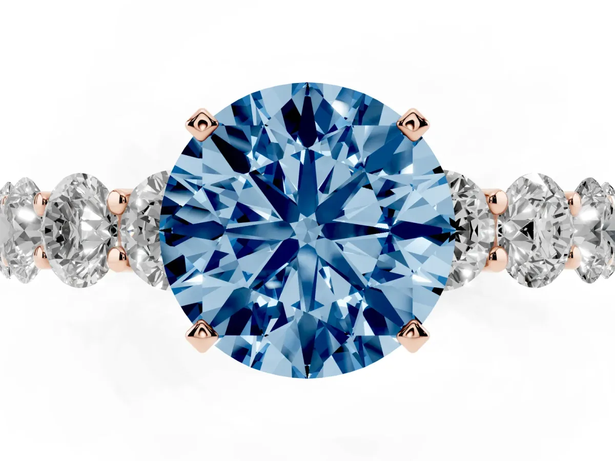 Fancy Blue Round Cut Diamond Prong Setting with Side Stones on a Pave Band Rose gold