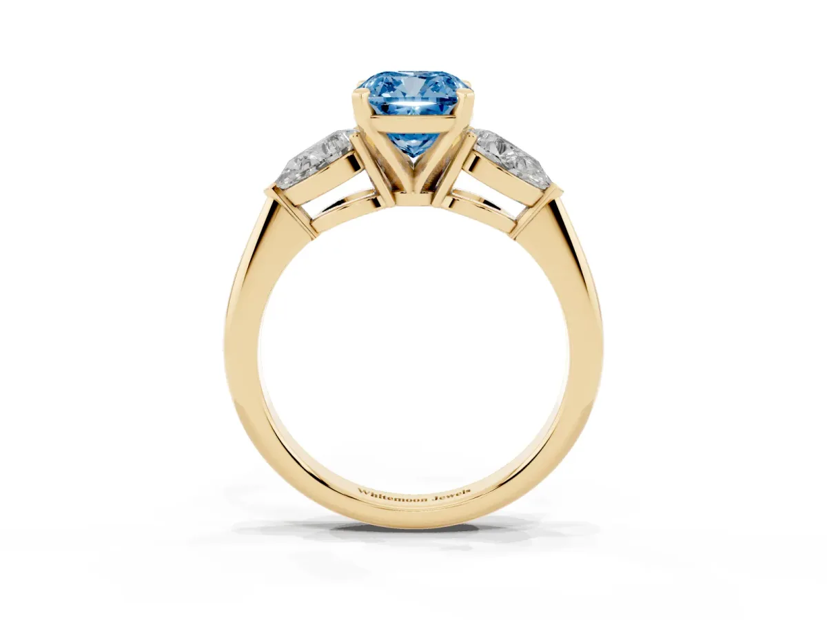 Fancy Blue Three-Stone Cushion Cut Diamond Ring with Pear Side Stones and Four-Prong Setting Yellow gold