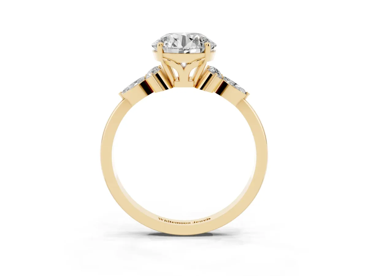 Round Cut Brilliant Diamond Solitaire Ring with Pear Side Stones and Four-Prong Setting Yellow gold