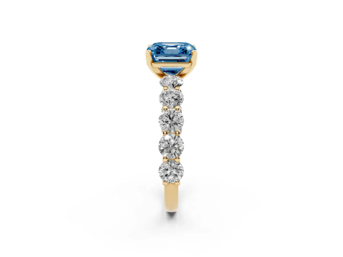 Fancy Blue Asscher Cut Diamond Prong Setting with Side Stones on a Pave Band Yellow gold