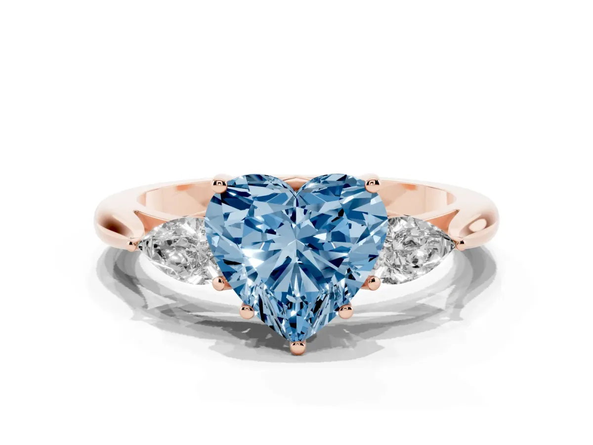Fancy Blue Three-Stone Heart Cut Brilliant Diamond Solitaire Ring with Tapered Band and Four-Prong Setting Rose gold