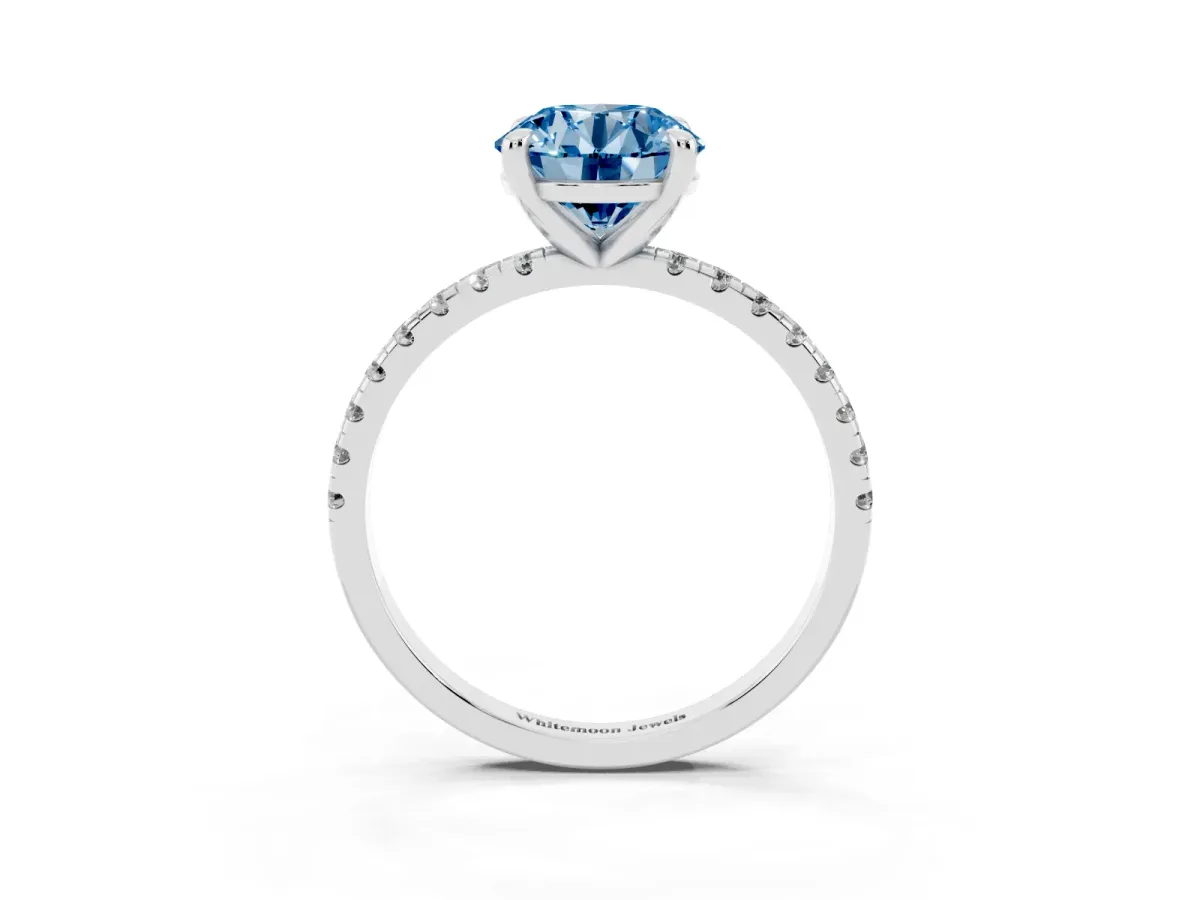 Fancy Blue Round Cut Diamond Brilliant Solitaire Ring with Pavé Band and Four-Prong Setting Platinum