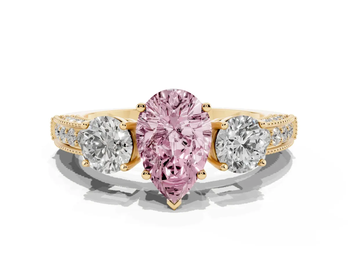 Fancy Pink Pear Cut Three-Stone Diamond Ring with Pavé Band and Four-Prong Setting Yellow gold