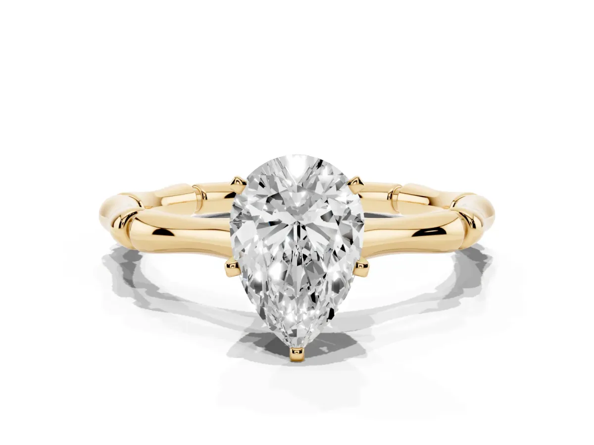 Pear Cut Solitaire Diamond Ring with Bamboo Band and Four-Prong Setting Yellow gold