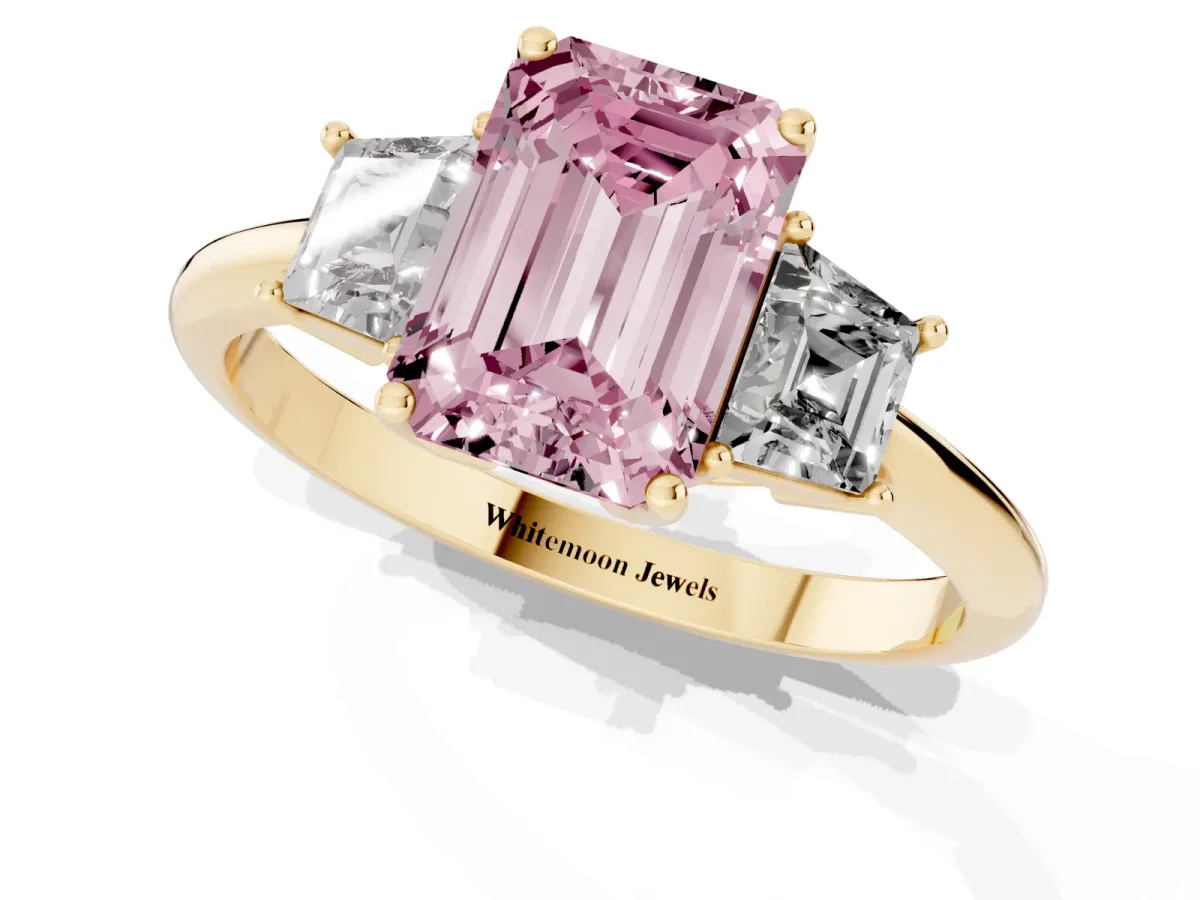 Fancy Pink Emerald Cut Diamond Three-Stone Ring with Trapezoid Side Stones and Prong Setting Yellow gold