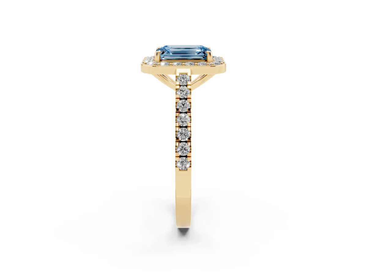 Fancy Blue Emerald Cut Diamond Halo Ring with Round Pavé Split Shank and Prong Setting Yellow gold
