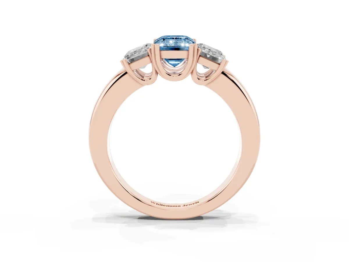 Fancy Blue Three-Stone Emerald Cut Cut Diamond Ring with Channel Set Band and Four-Prong Setting Rose gold
