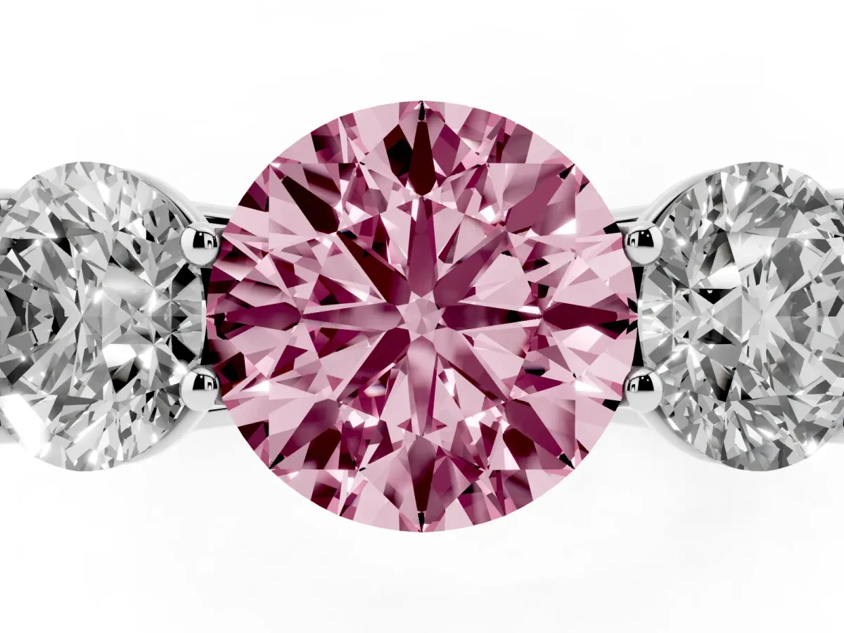 Fancy Pink Round Cut Three-Stone Diamond Ring with Prong Setting on a Classic Band Platinum