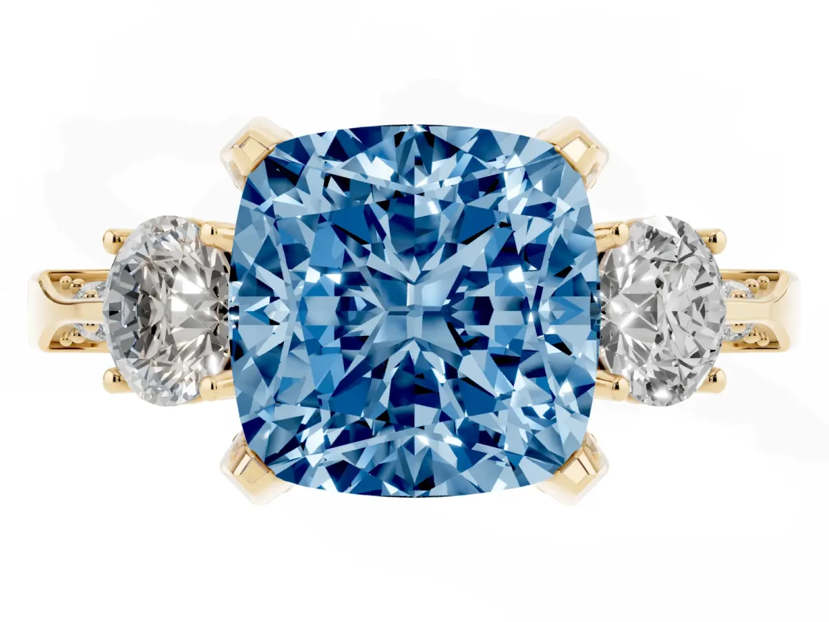 Fancy Blue Cushion Cut Brilliant Three-Stone Diamond Ring with Pavé Band and Four-Prong Setting Yellow gold