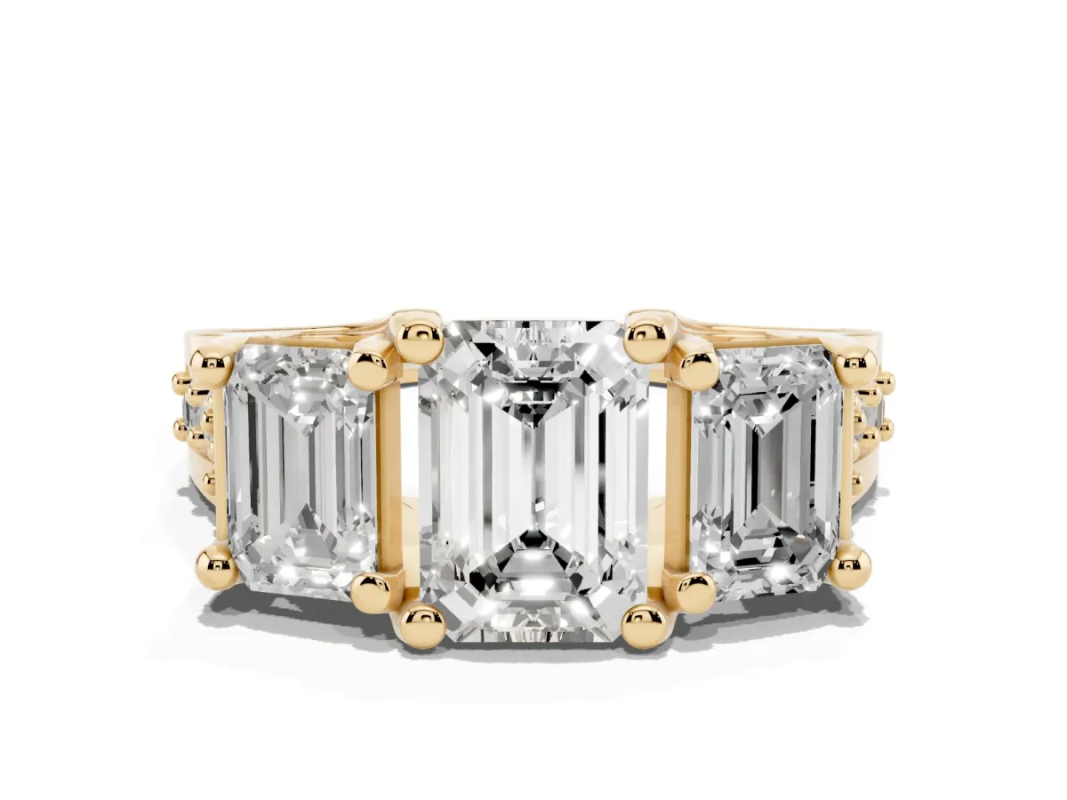 Emerald Cut Diamond Three-Stone Ring with Channel Set Band and Four-Prong Setting Yellow gold