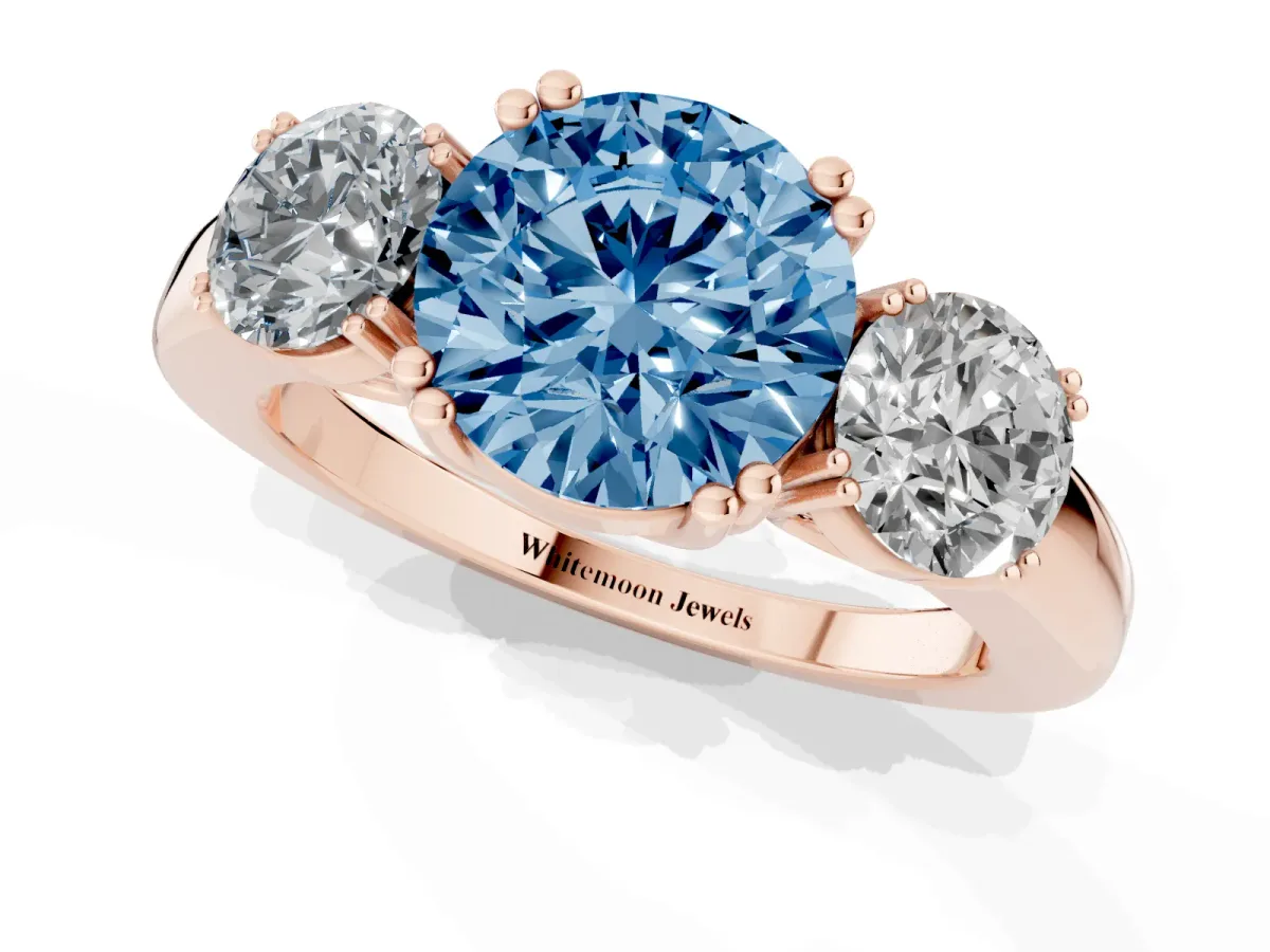 Fancy Blue Three-Stone Round Cut Cut Diamond Ring with Channel Set Band and Four-Prong Setting Rose gold