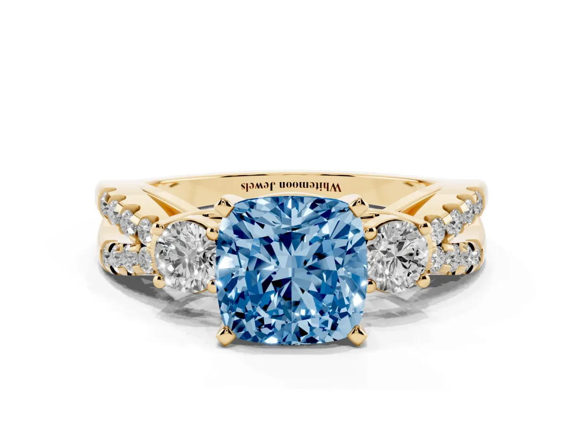 Fancy Blue Cushion Cut Diamond Three-Stone Ring with Pavé Split Shank and Four-Prong Setting Yellow gold