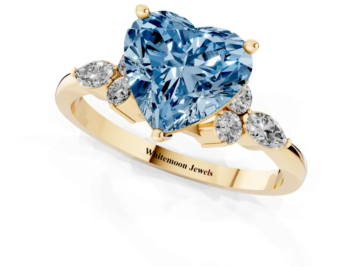 Fancy Blue Heart Cut Brilliant Diamond Solitaire Ring with Pear Side Stones and Four-Prong Setting Yellow gold