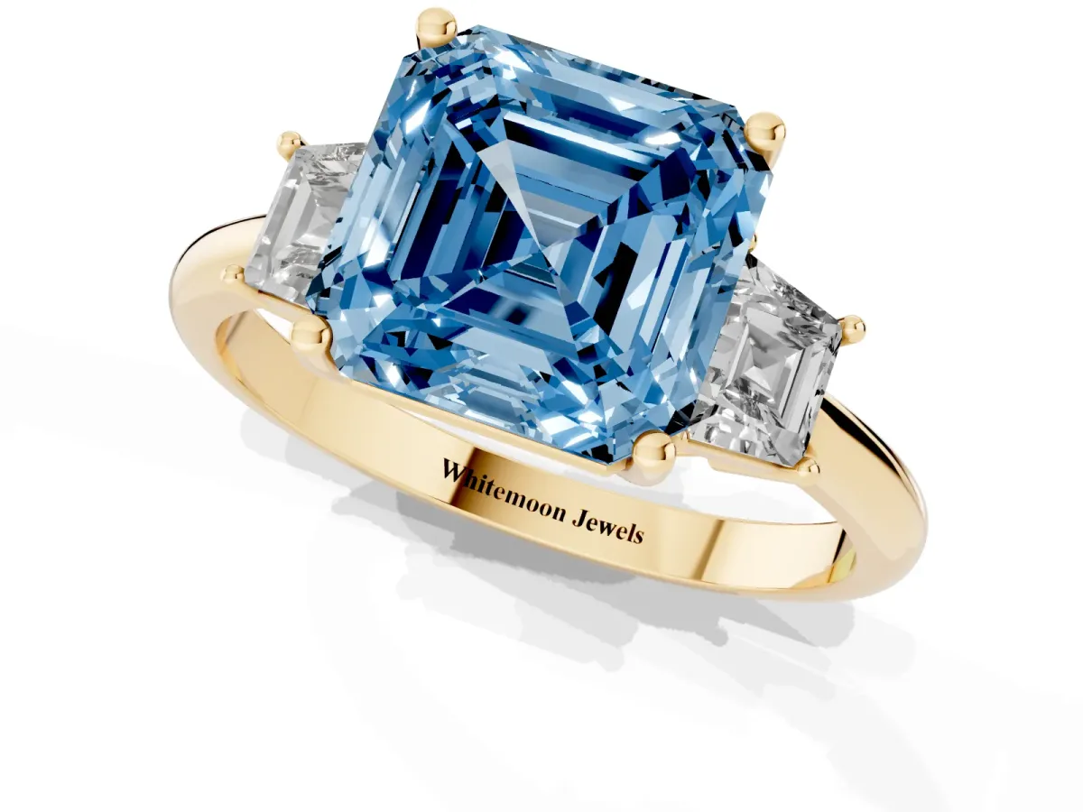 Fancy Blue Asscher Cut Diamond Three-Stone Ring with Trapezoid Side Stones and Prong Setting Yellow gold