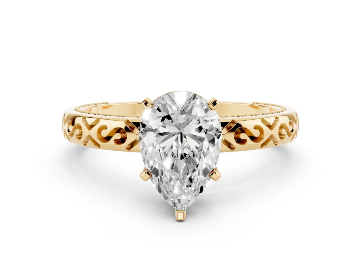 Pear Cut Solitaire Engagement Ring with Scrollwork Band and Four-Prong Setting Yellow gold