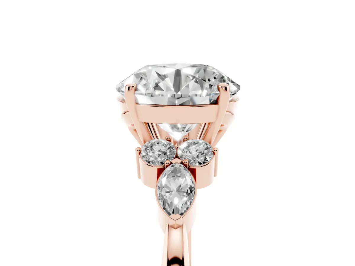 Round Cut Brilliant Diamond Solitaire Ring with Pear Side Stones and Four-Prong Setting Rose gold